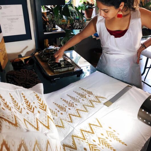 Create wearable hand-stamped batik fabric in my home studio